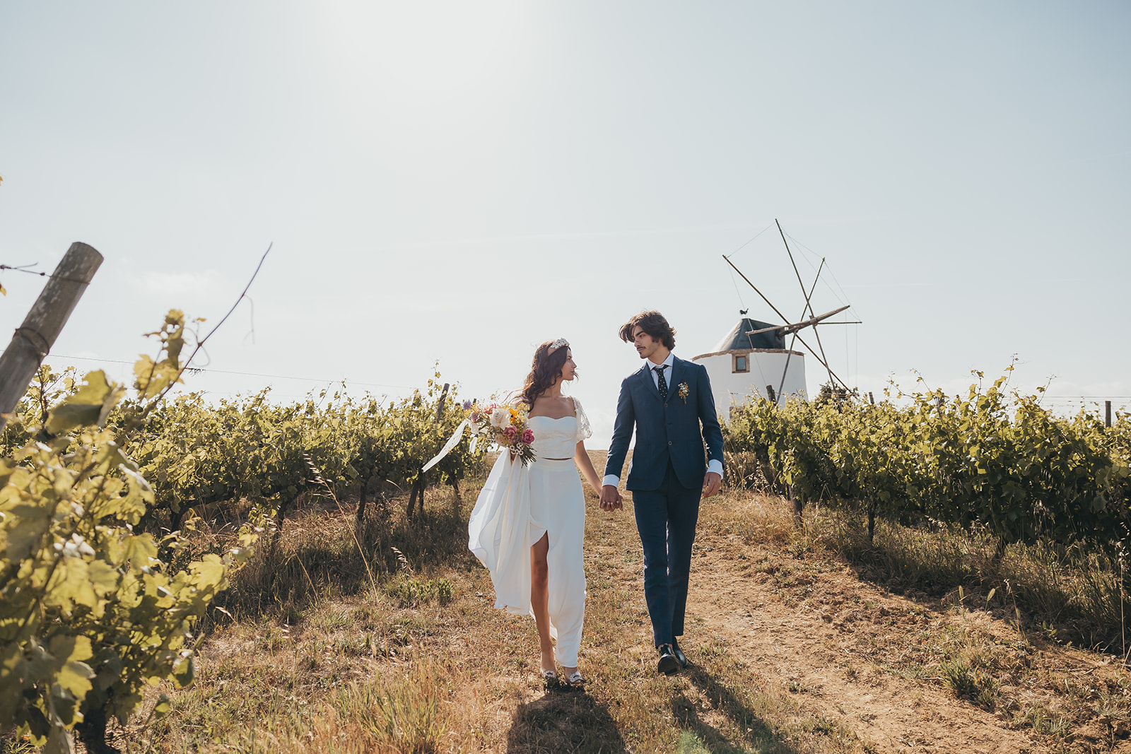 A couple in wedding attire walks during their elopement wedding in Portugal