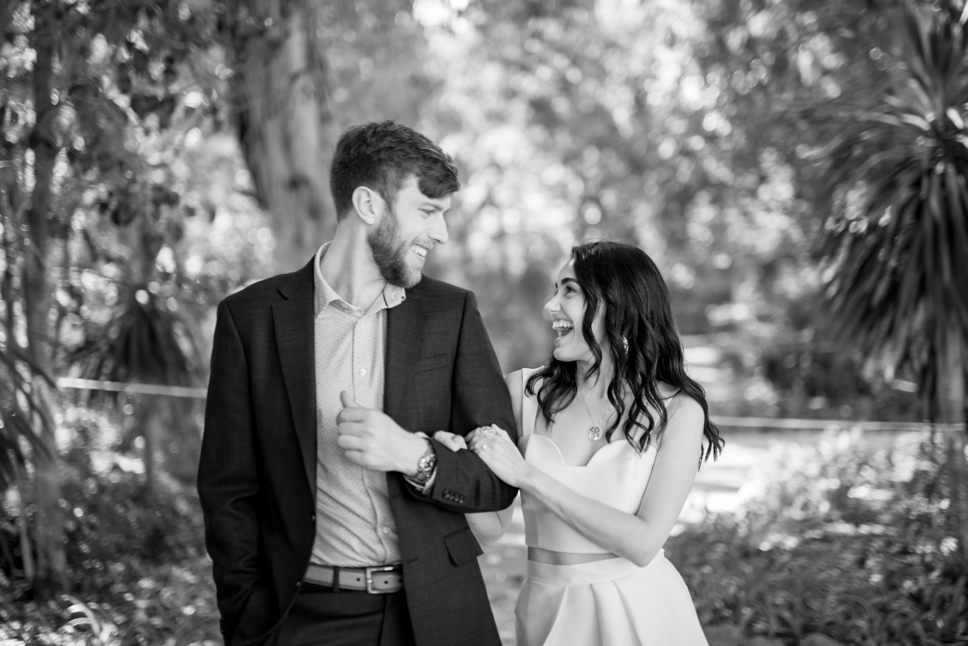 A couple laughing poses for their perfect destination wedding in cascais