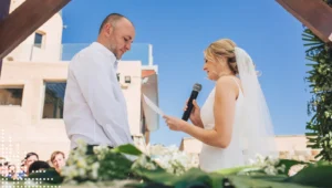Couple exchanging vows outdoors under clear sky
